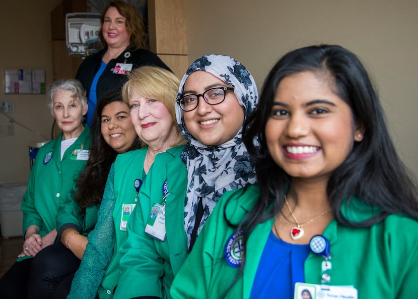 Nurse manager Cyndi Kelley (standing) relies on volunteers including (from left) Danna Orr,...