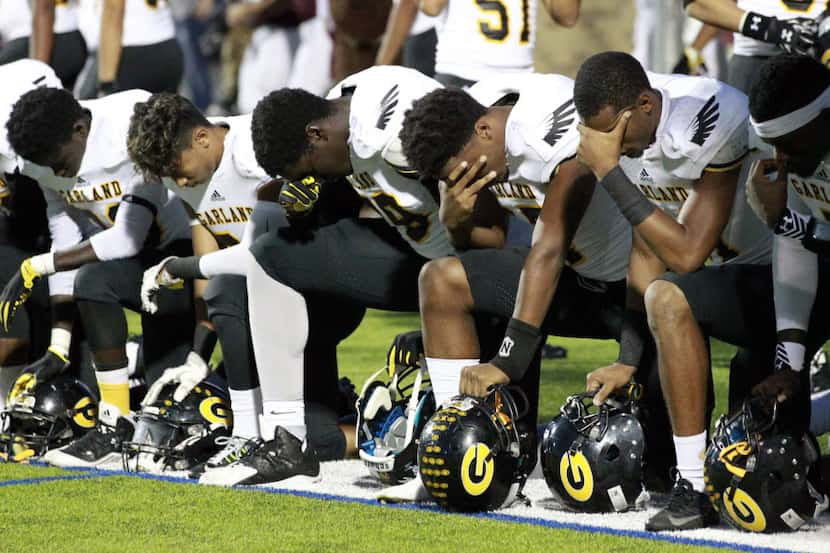 Garland players, including Hakeem Adeniji (79); Melvin Loveless (17) and Coree Comption (11)...