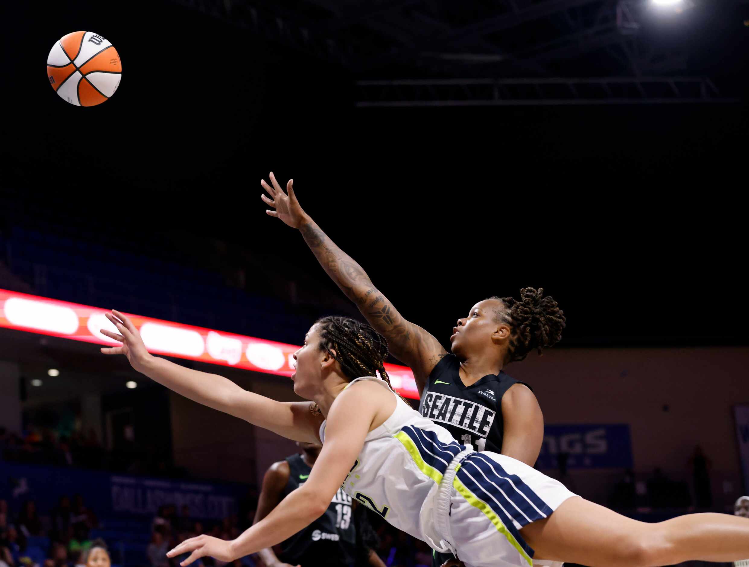 Dallas Wings guard Veronica Burton (12) extends herself for a layup against Seattle Storm...
