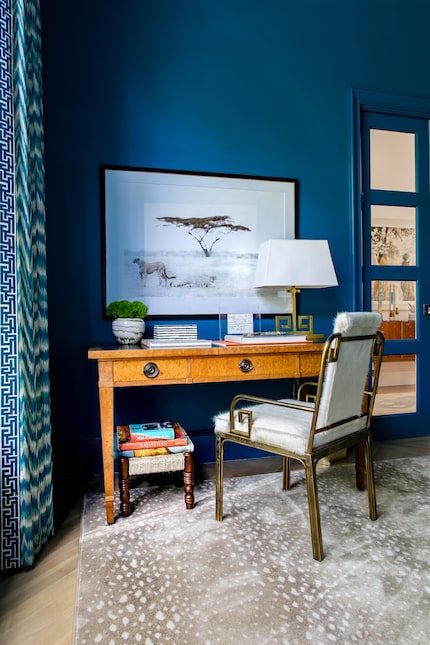 An antique desk from Brooke Drake Design is paired with a brass desk chair from 1stDibs...