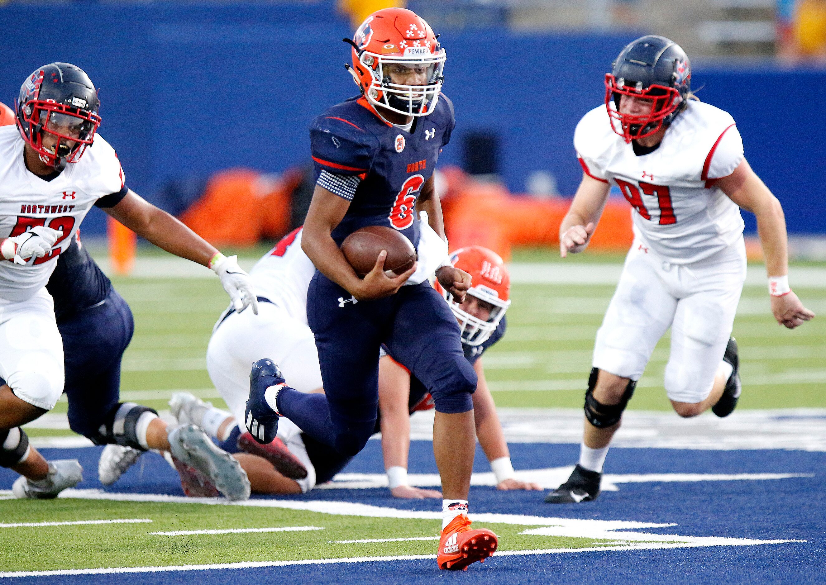 McKinney North High School quarterback Gavin Constantine ll (6) keeps the ball for a big...