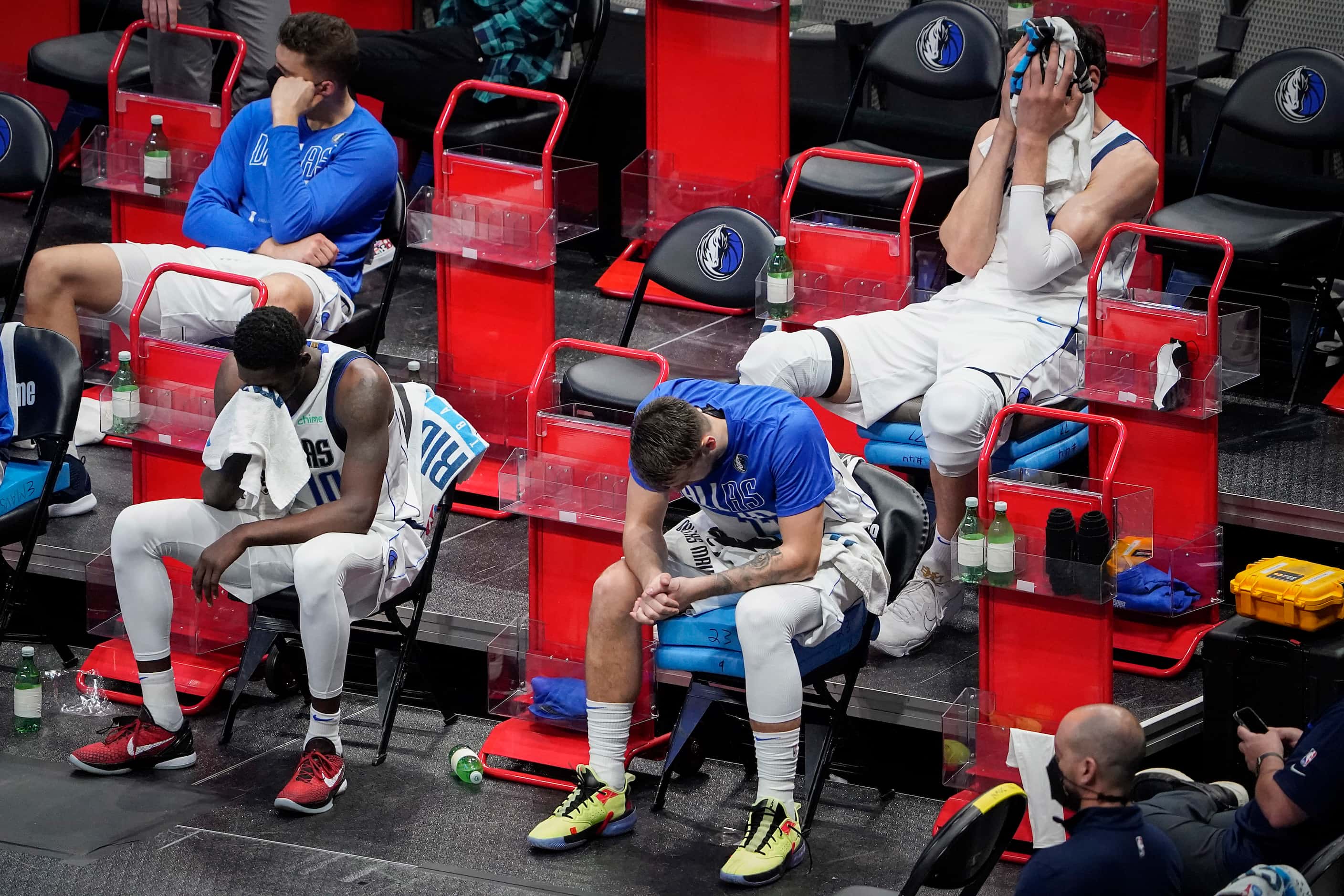Dallas Mavericks guard Luka Doncic sits (bottom right) on the bench with forward Dorian...