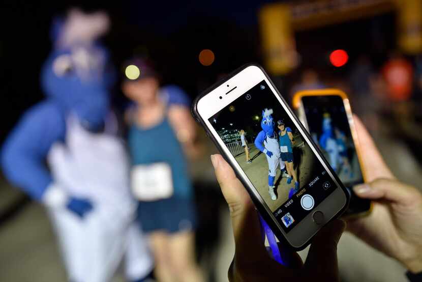 Honor Hill, 77, of Dallas, is photographed with the Mavericks mascot Champ, left, after she...