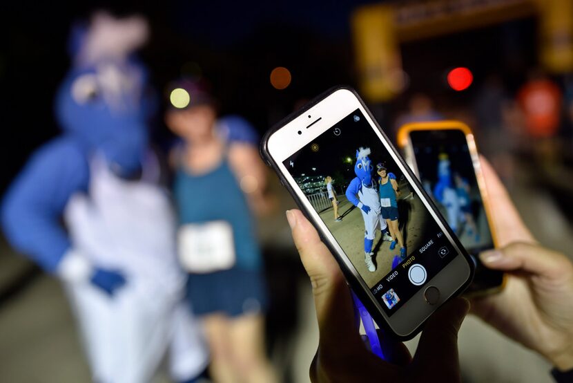 Honor Hill, 77, of Dallas, is photographed with the Mavericks mascot Champ, left, after she...