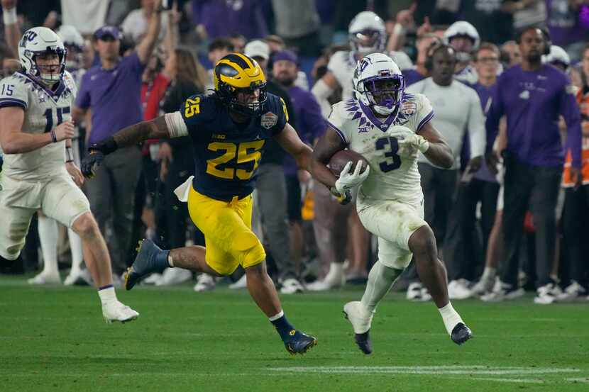 TCU running back Emari Demercado (3) breaks free from Michigan linebacker Junior Colson (25)...