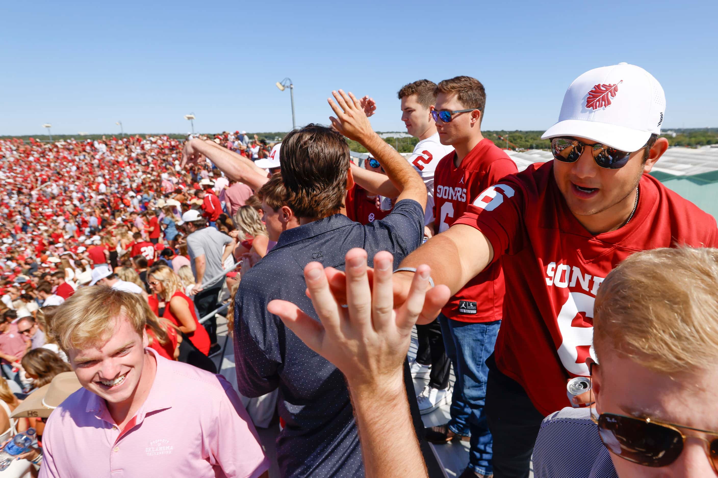 Oklahoma fans high fives after the first half of the Red River Rivalry against Texas at the...