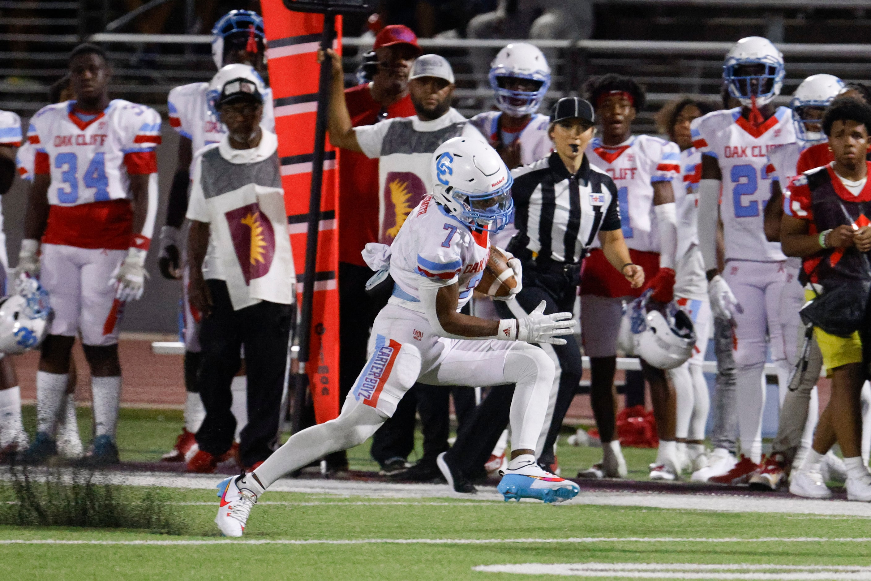 Carter high’s Kaeden Landry runs for a yardage against Kimball high during the second half...