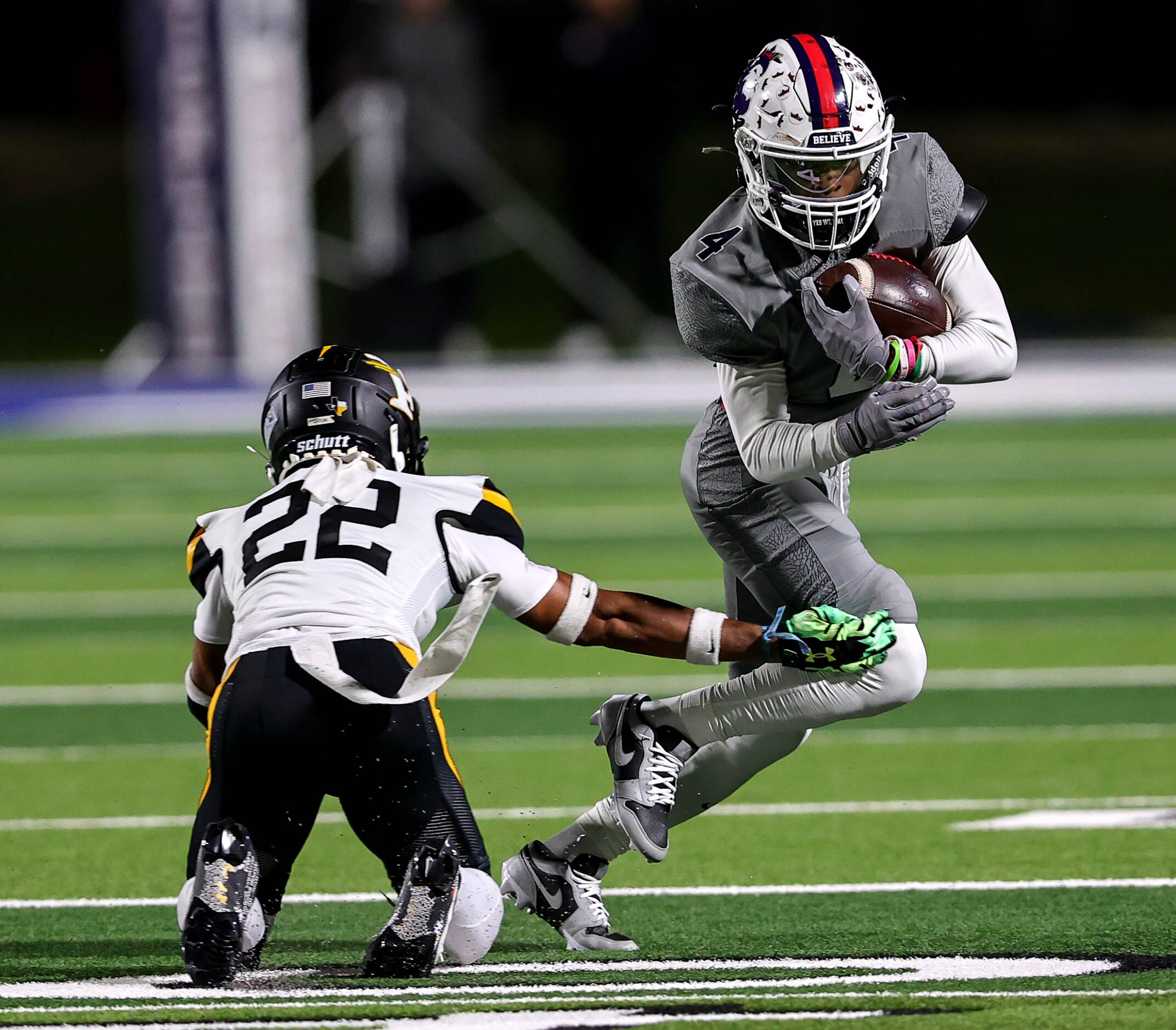 Richland wide receiver Deon Jones (4) tries to elude Forney defensive back Joshua Gatlin...