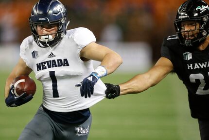 FILE - Hawaii linebacker Solomon Matautia (27) tries to pull down Nevada wide receiver...