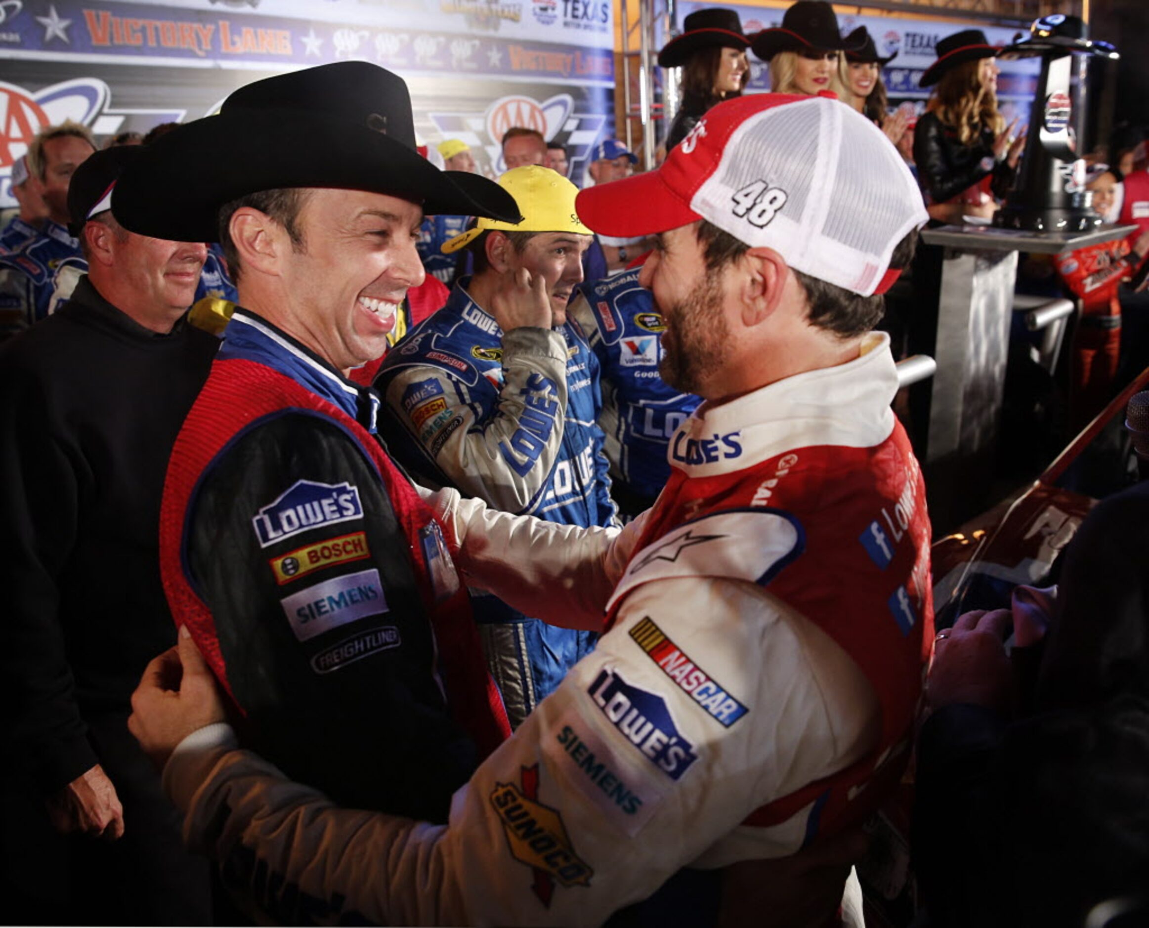 Sprint Cup Series driver Jimmie Johnson, right, celebrates his AAA Texas 500 win in Victory...