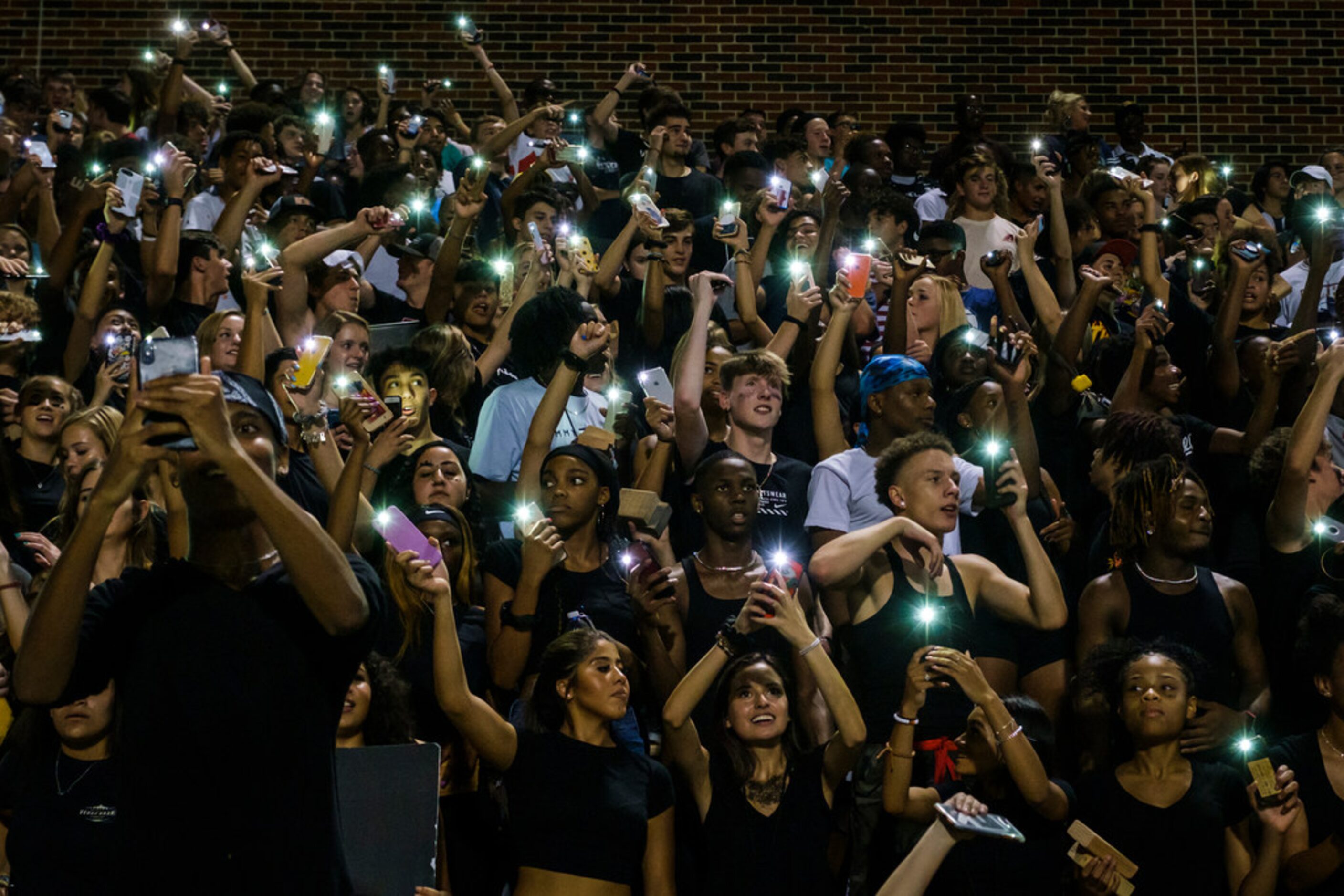 Frisco Lone Star fans cheer on their team during the second half of a high school football...