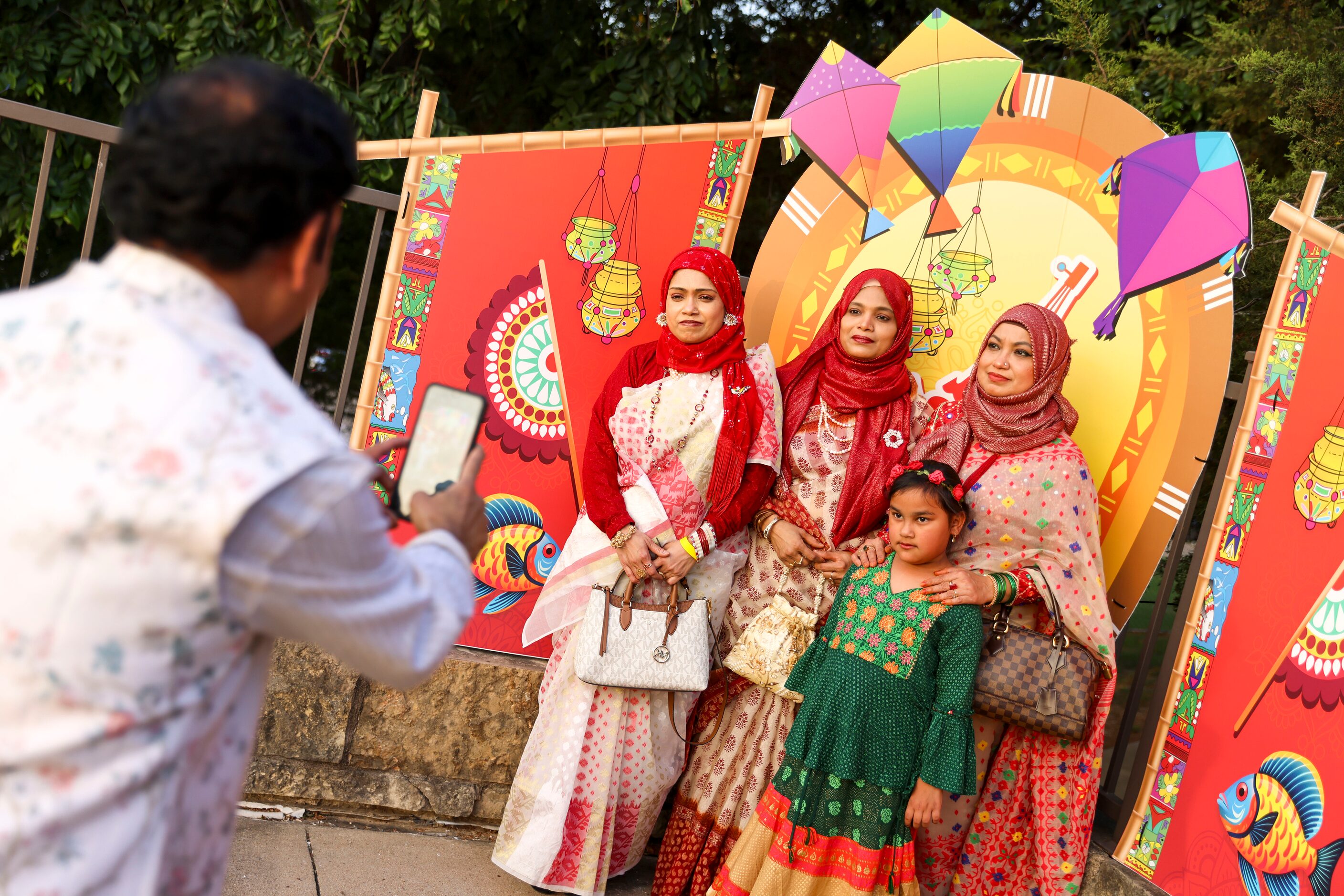 People take photos in front of a cut out during a Boishakhi Mela hosted by Bangladesh...