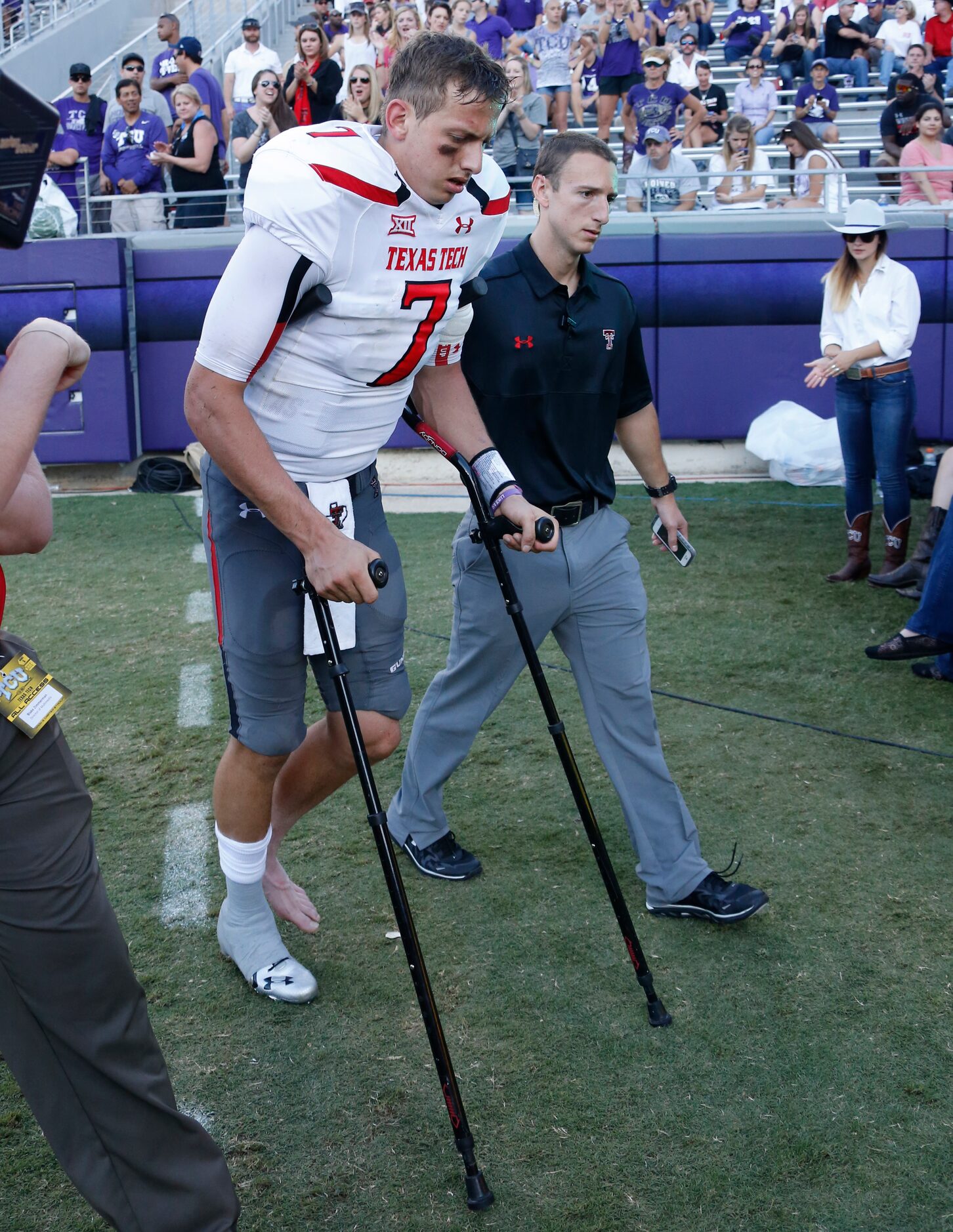 Texas Tech Red Raiders quarterback Davis Webb (7) leaves the field on crutches after being...