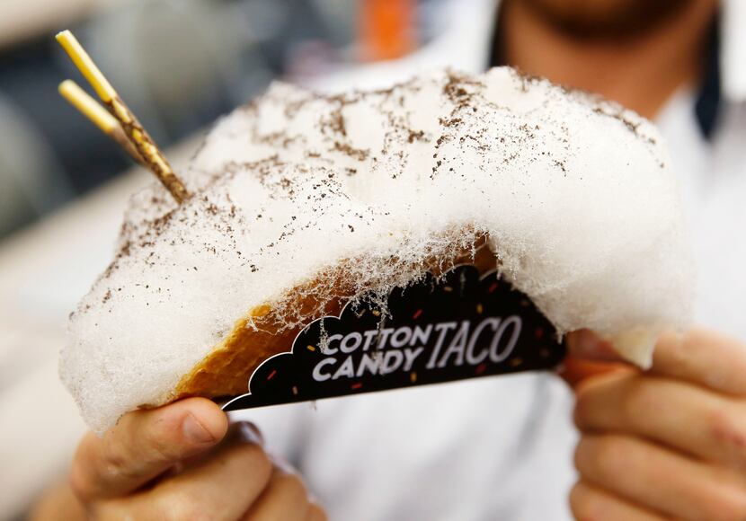 Justin Martinez holds up a Cotton Candy Taco during the unveiling of the Big Tex Choice...