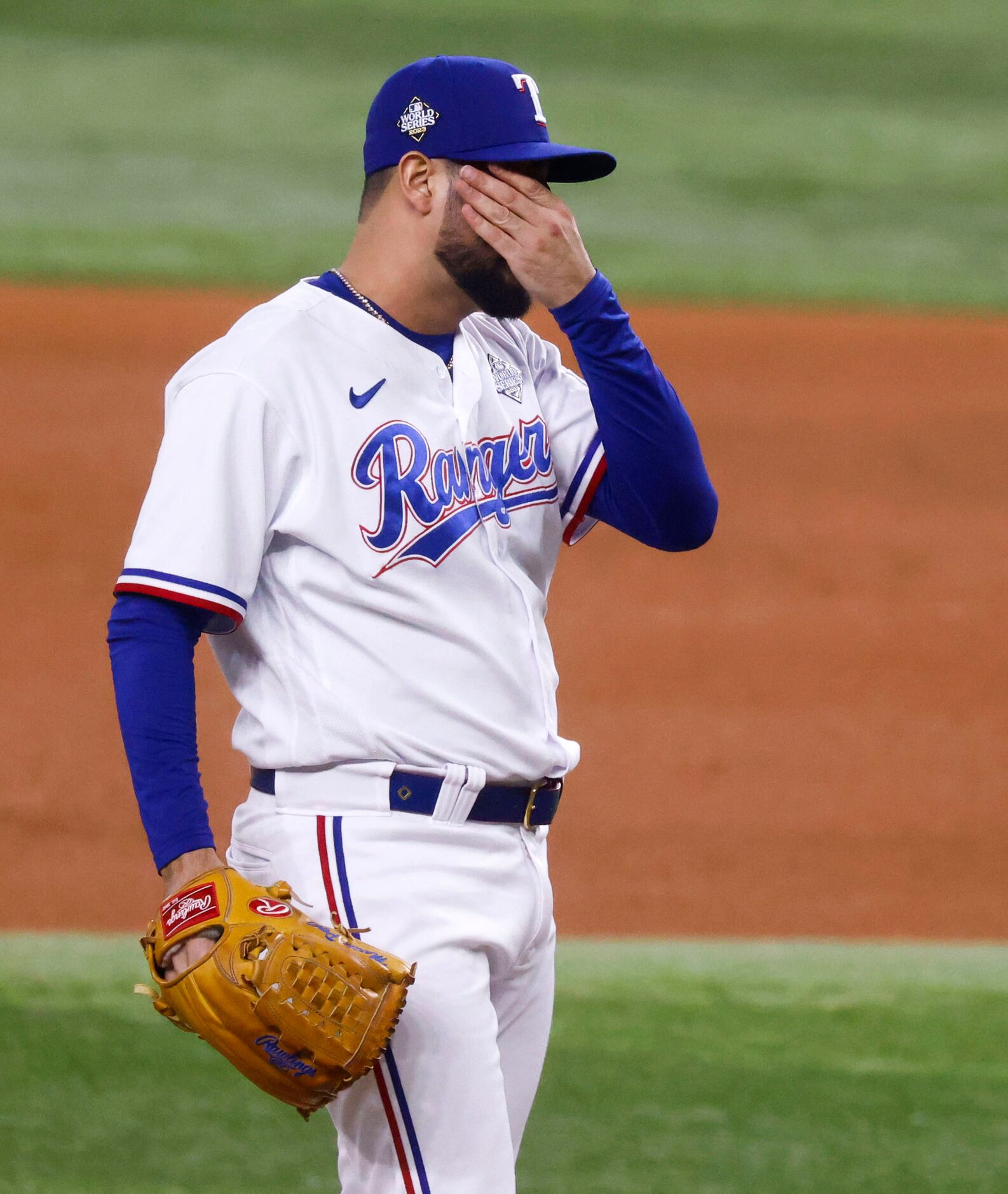 Texas Rangers’ Martín Pérez wipes his face in the eighth inning against Arizona Diamondbacks...