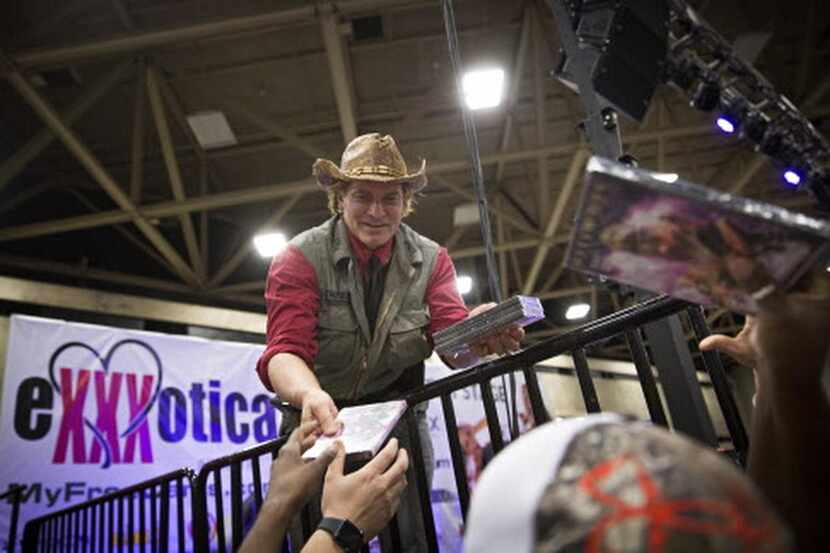 
Adult entertainment star Evan Stone hands out DVDs during the Exxxotica Expo 2015.
