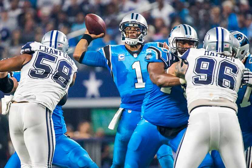 Carolina Panthers quarterback Cam Newton (1) throws a pass under pressure from Dallas...
