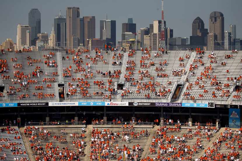 The Dallas skyline rose above socially distanced Texas fans during the first quarter of the...