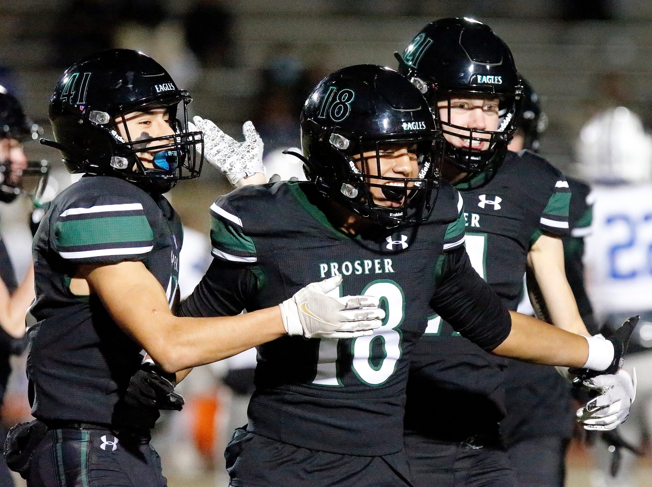 Prosper High School’s Ethan Guintu (18) is congratulated by team mates after making a big...