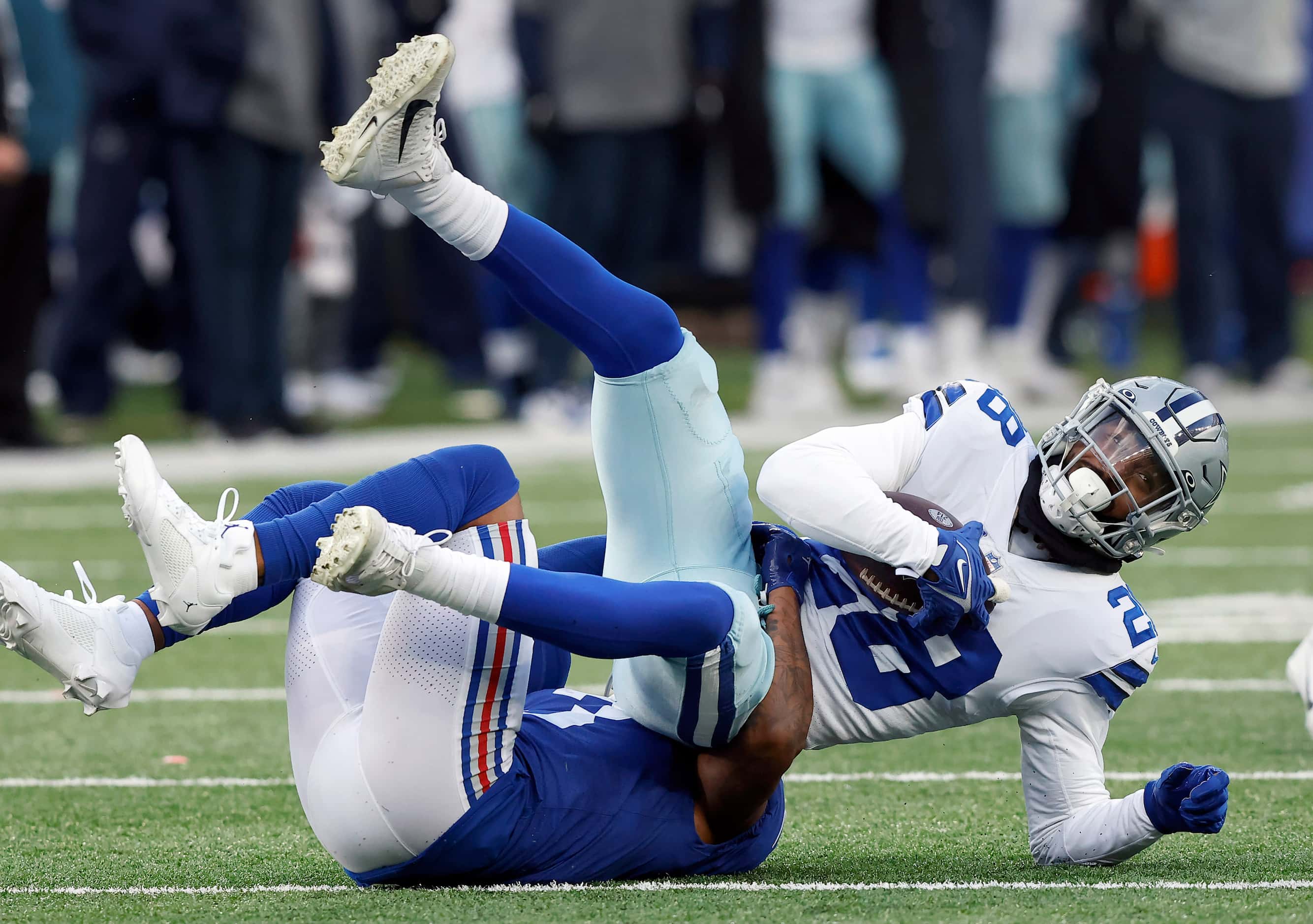 Dallas Cowboys safety Malik Hooker (28) is tackled by New York Giants wide receiver Sterling...