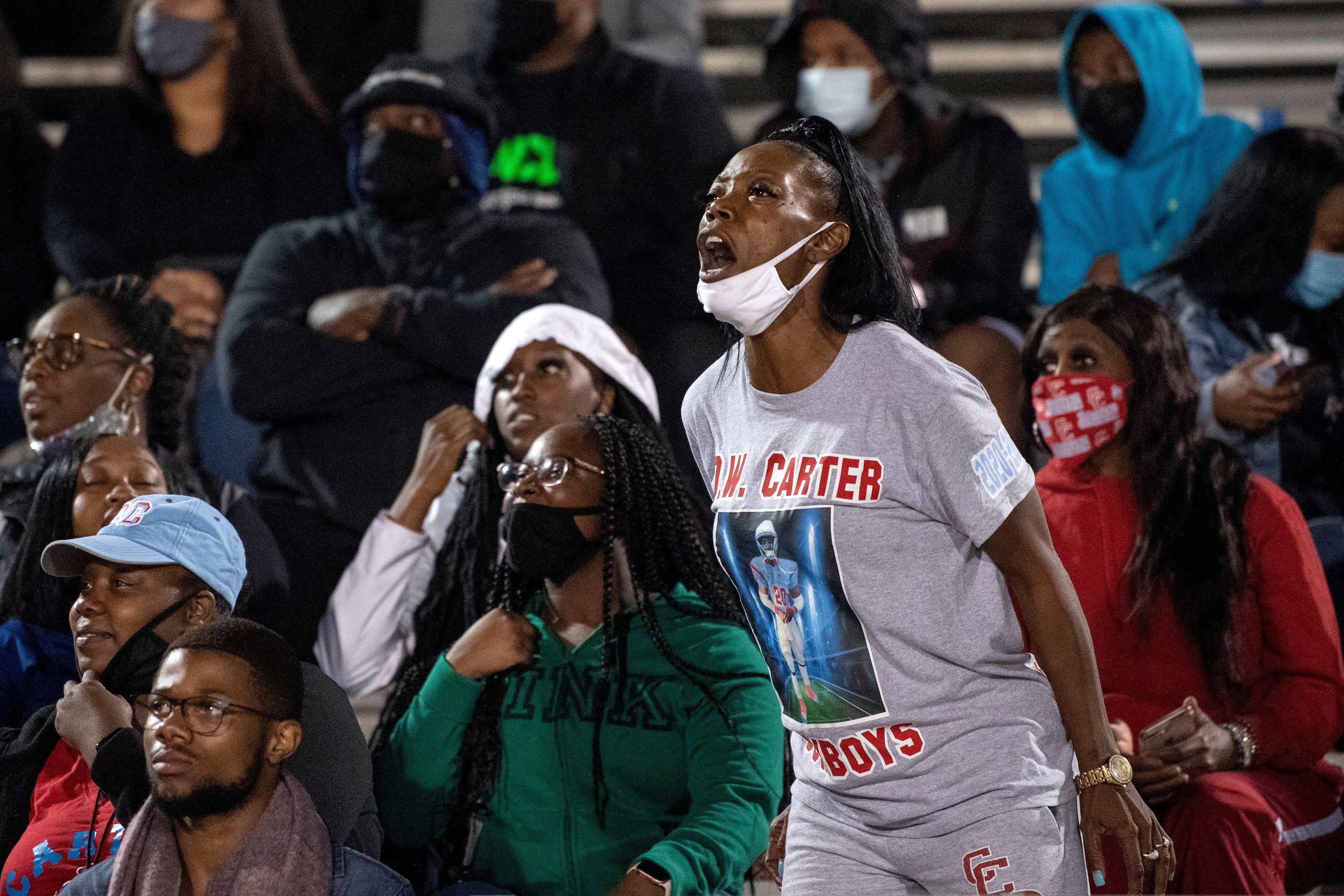 Keisha Mitchell, mother of Carter senior defensive back Jy’Quavion Vinson, yells from the...