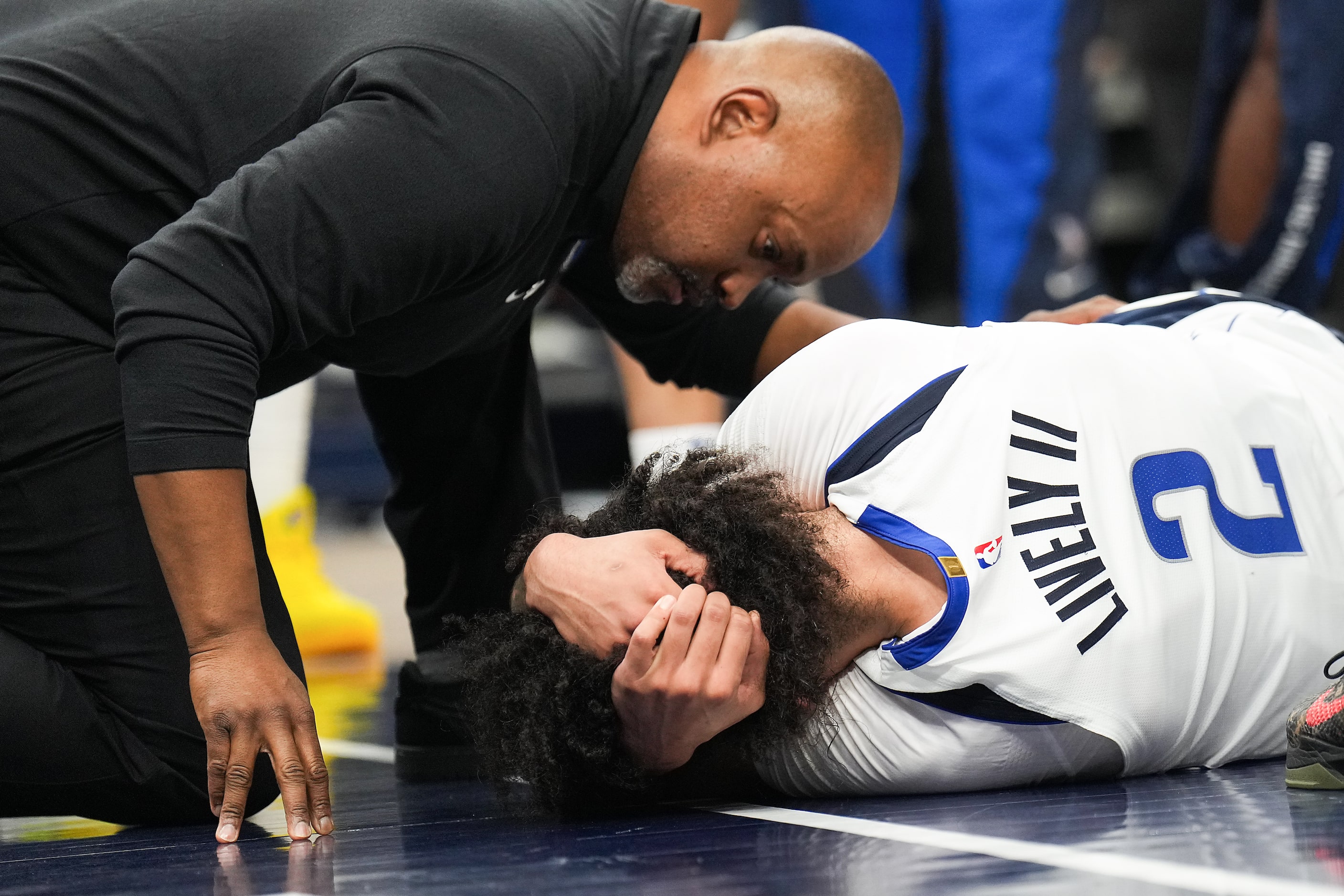 Dallas Mavericks center Dereck Lively II lies on the floor after being fouled during the...