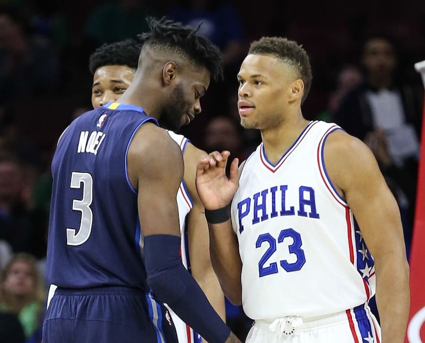 Philadelphia 76ers guard Justin Anderson (23) chats with Dallas Mavericks' Nerlens Noel (3)...