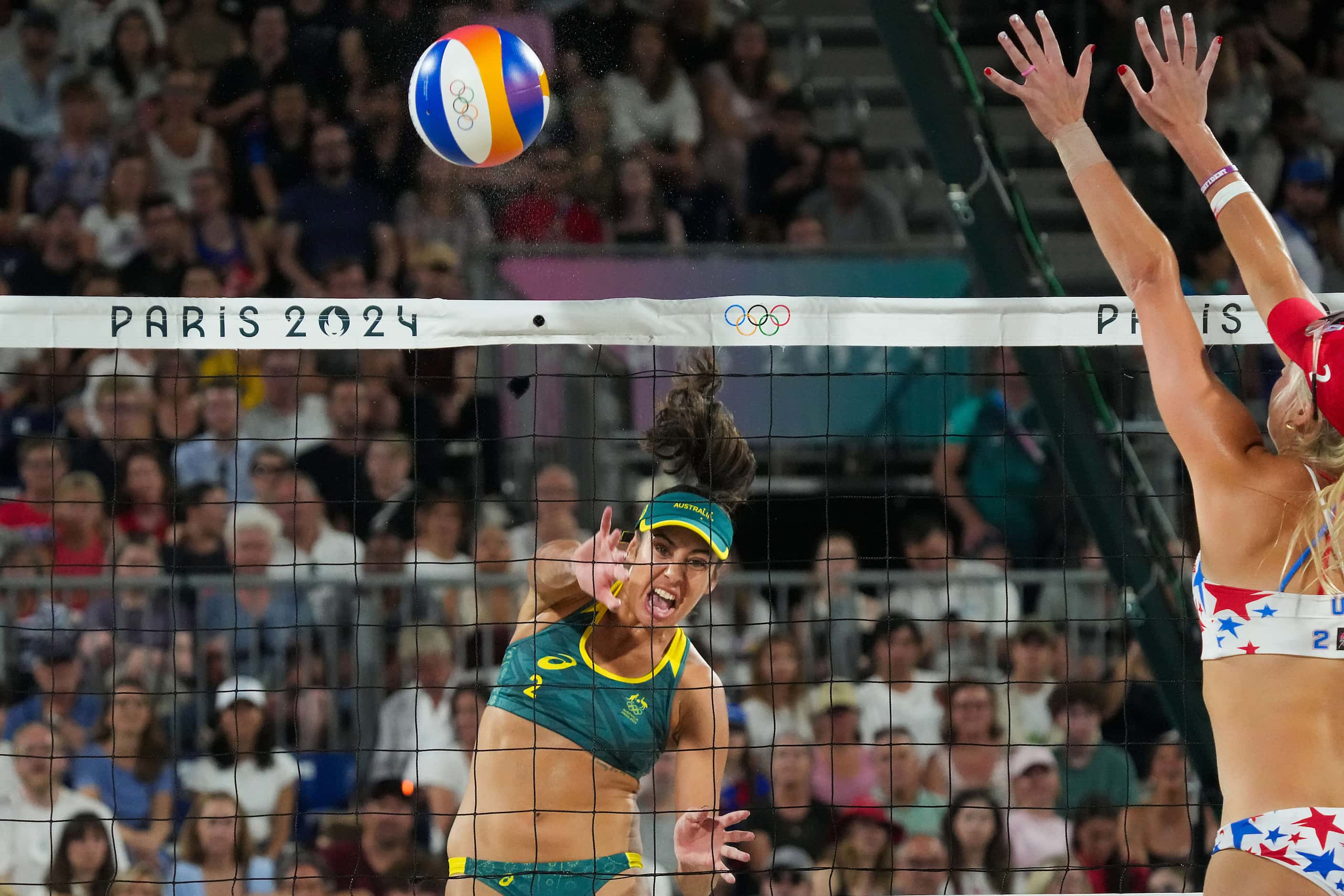Taliqua Mariafe Clancy of Australia hits the ball as Taryn Kloth of the United States goes...