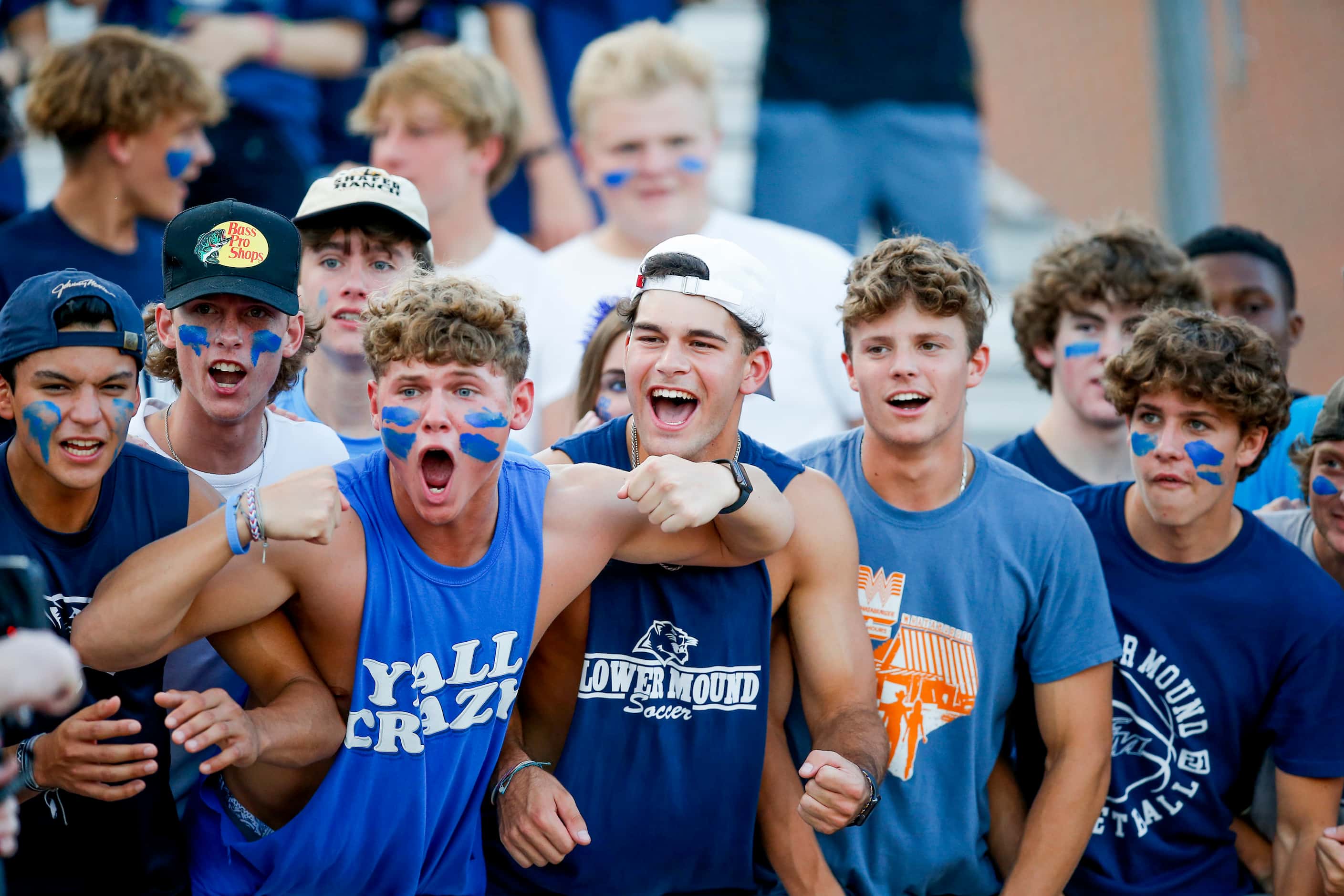 Flower Mound fans cheer for their team during the first half of a high school football game...