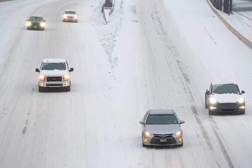 Traffic seen on a snowy and icy North Central Expressway in Dallas on Feb. 17, 2021.