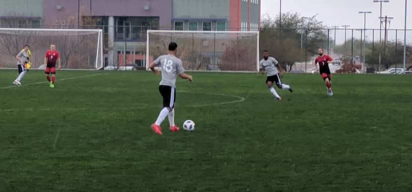 Brandon Servania (18) holds possession versus the University of Arizona. (2-16-18)