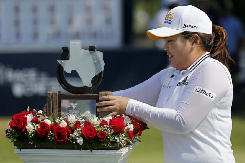 Inbee Park of North Korea picks up her trophy during the final round of the Volunteers of...