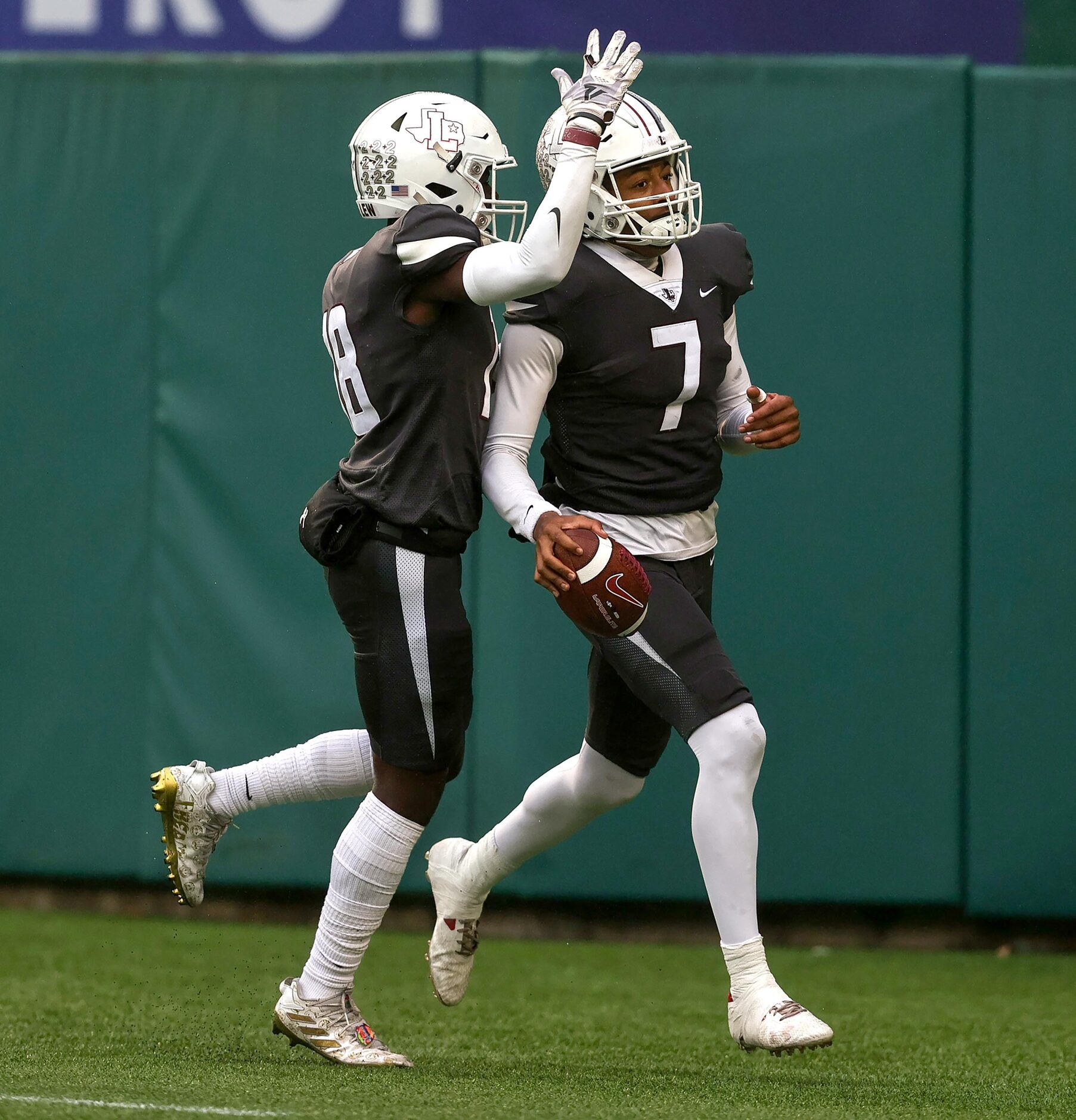 Lewisville quarterback Ethan Terrell (7) celebrates with wide receiver Tye Miller (18) after...