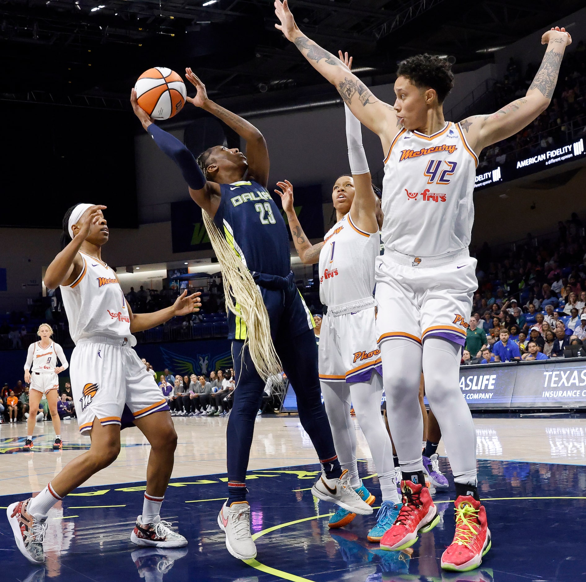 Phoenix Mercury center Brittney Griner (42) and guards Sug Sutton (1) and Shey Peddy (11)...