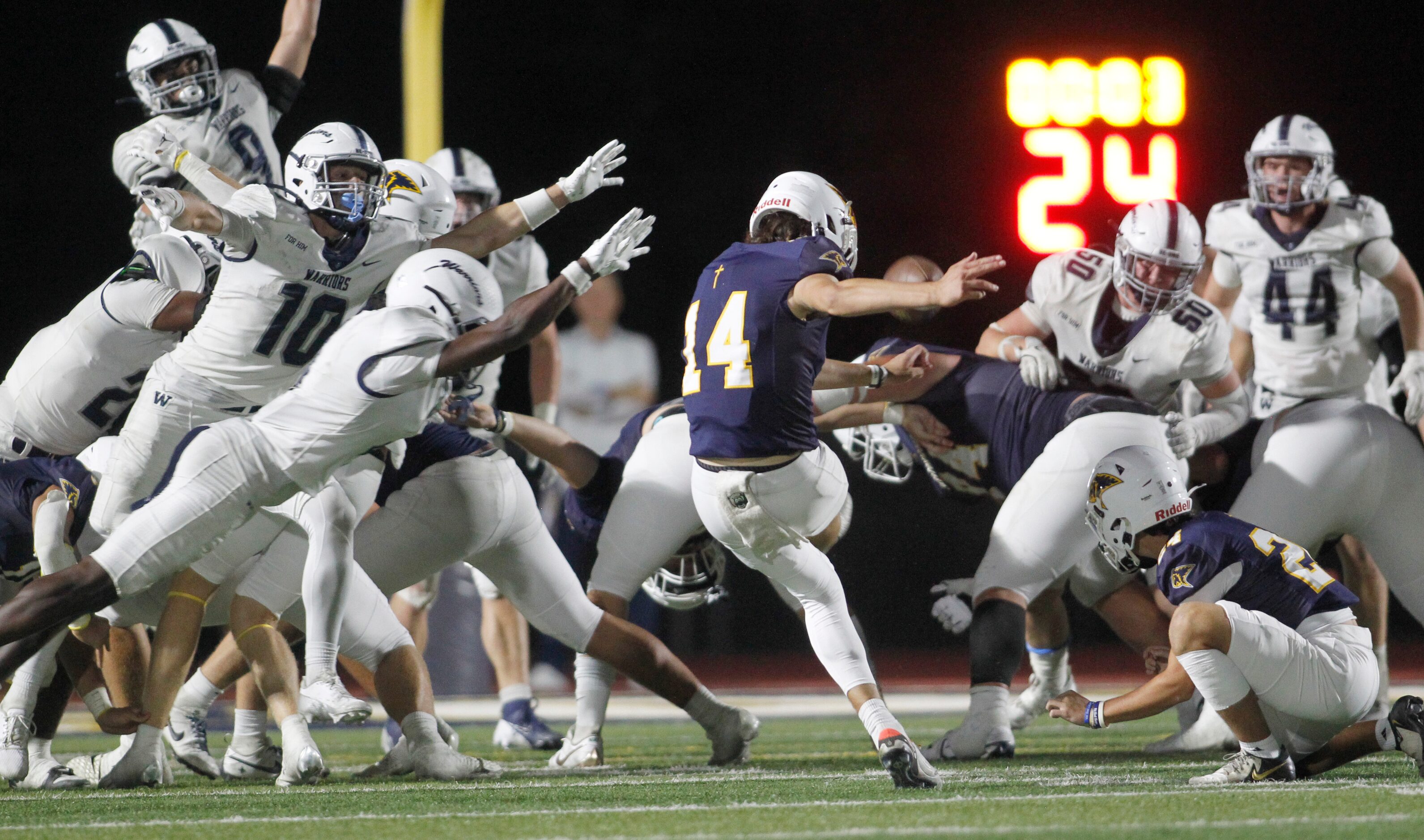 Plano Prestonwood Christian kicker Justin Dewers (14), center, kicks successful field goal...