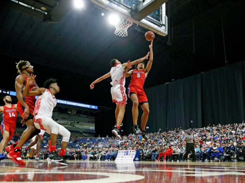 Duncanville's Micah Peavy #5 scores over Galena Park North's Joshua Cooper #0.UIL boys...