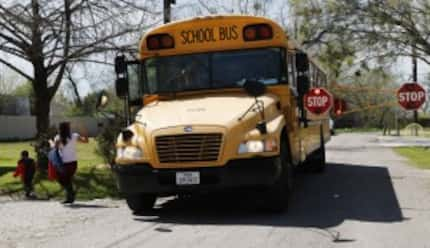  Jesica Fuentes waves to McKinney ISD bus driver Bruce Austin, as her son, Jonathan Arzola,...