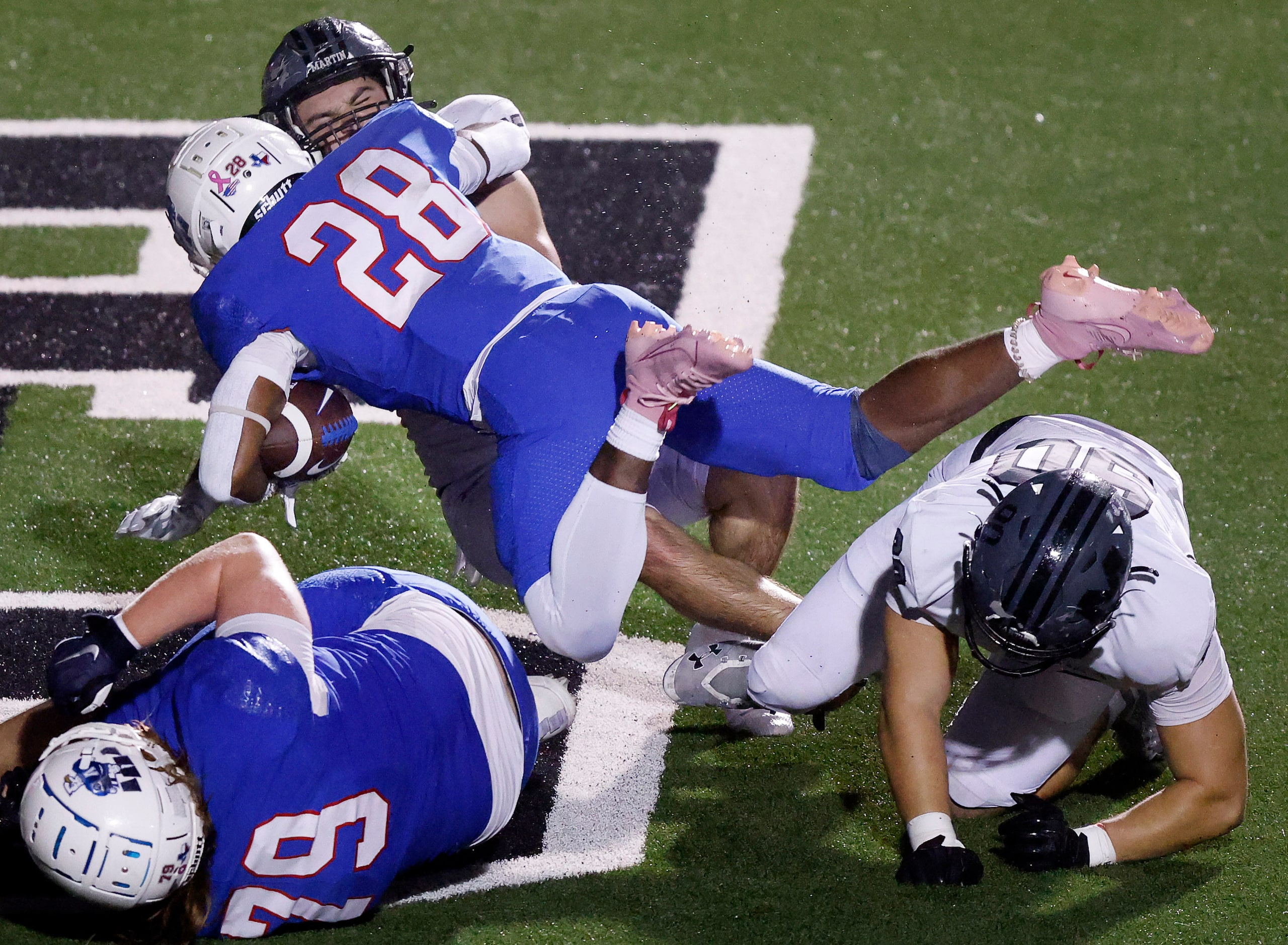 Allen running back Amir McDowell (28) bowls over Arlington Martin defensive back D'Juan...