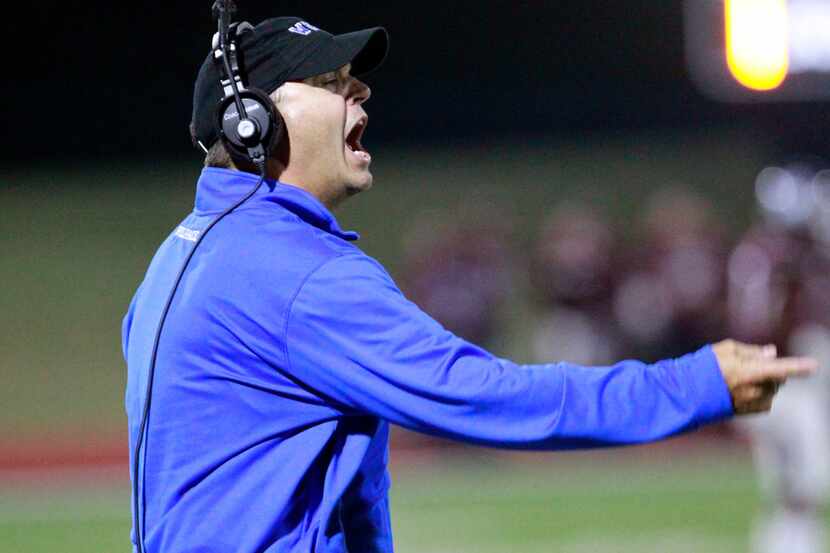 Plano East coach Scott Smith yells instructions to team members during the first half of a...