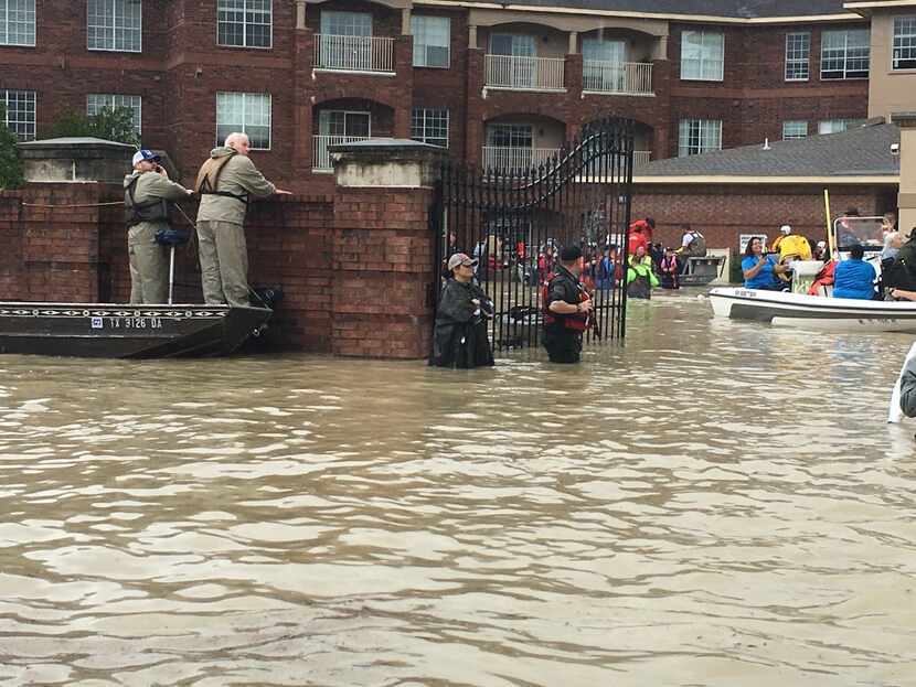 Rescue workers Tuesday outside the Arbor Terrace retirement community in the Kingwood...