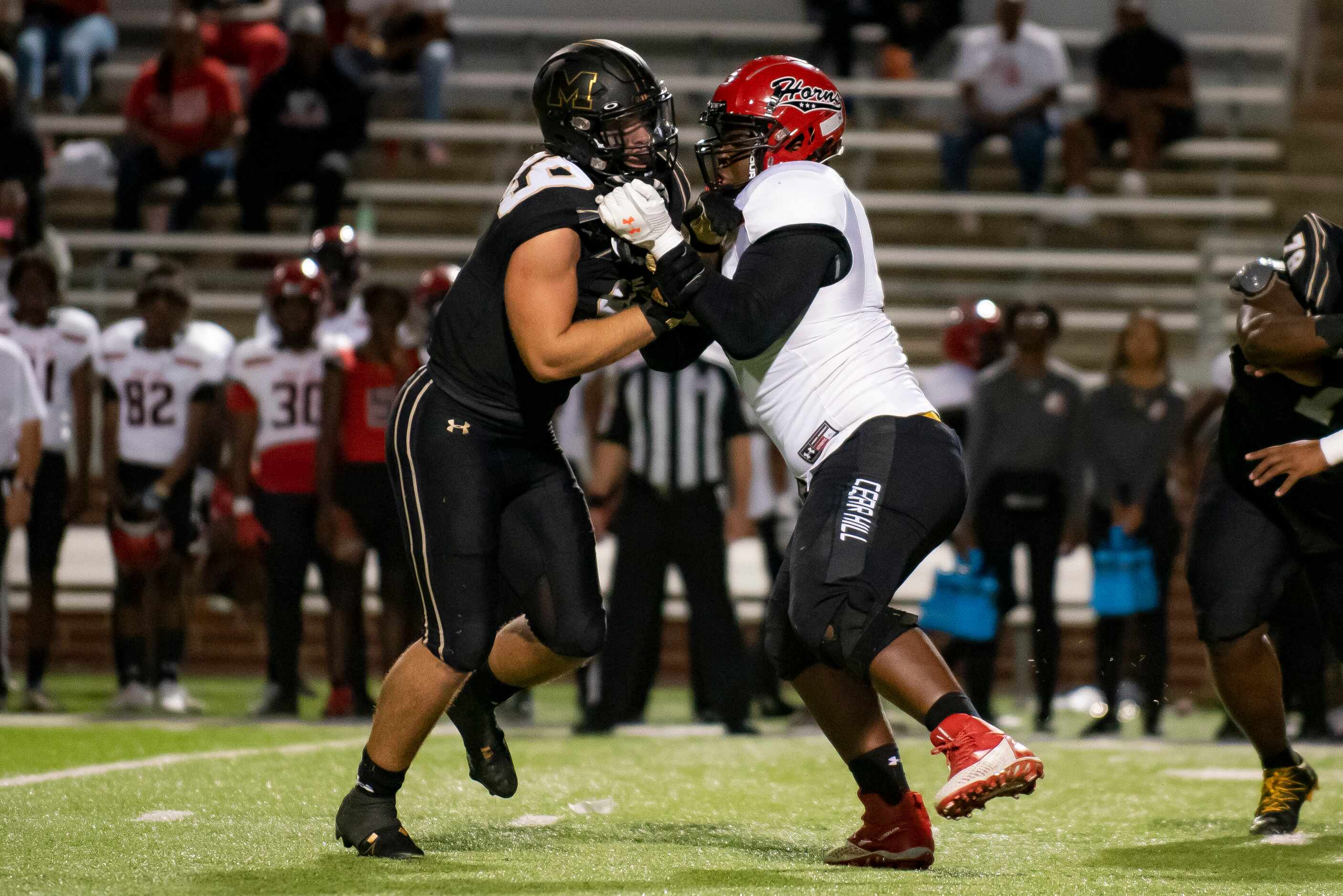 From left, Mansfield senior Kaleb James (99) attempts to get past Cedar Hill sophomore...