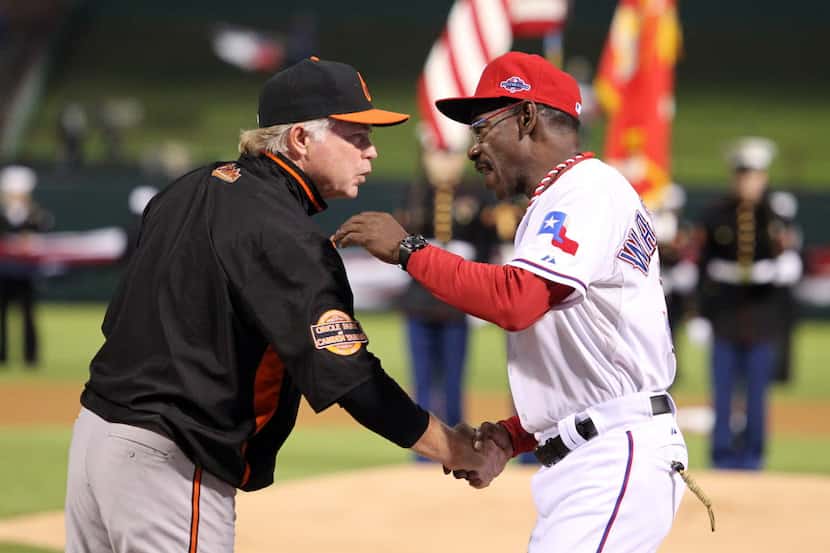 Baltimore Orioles manager Buck Showalter (26) greets Texas Rangers manager Ron Washington...