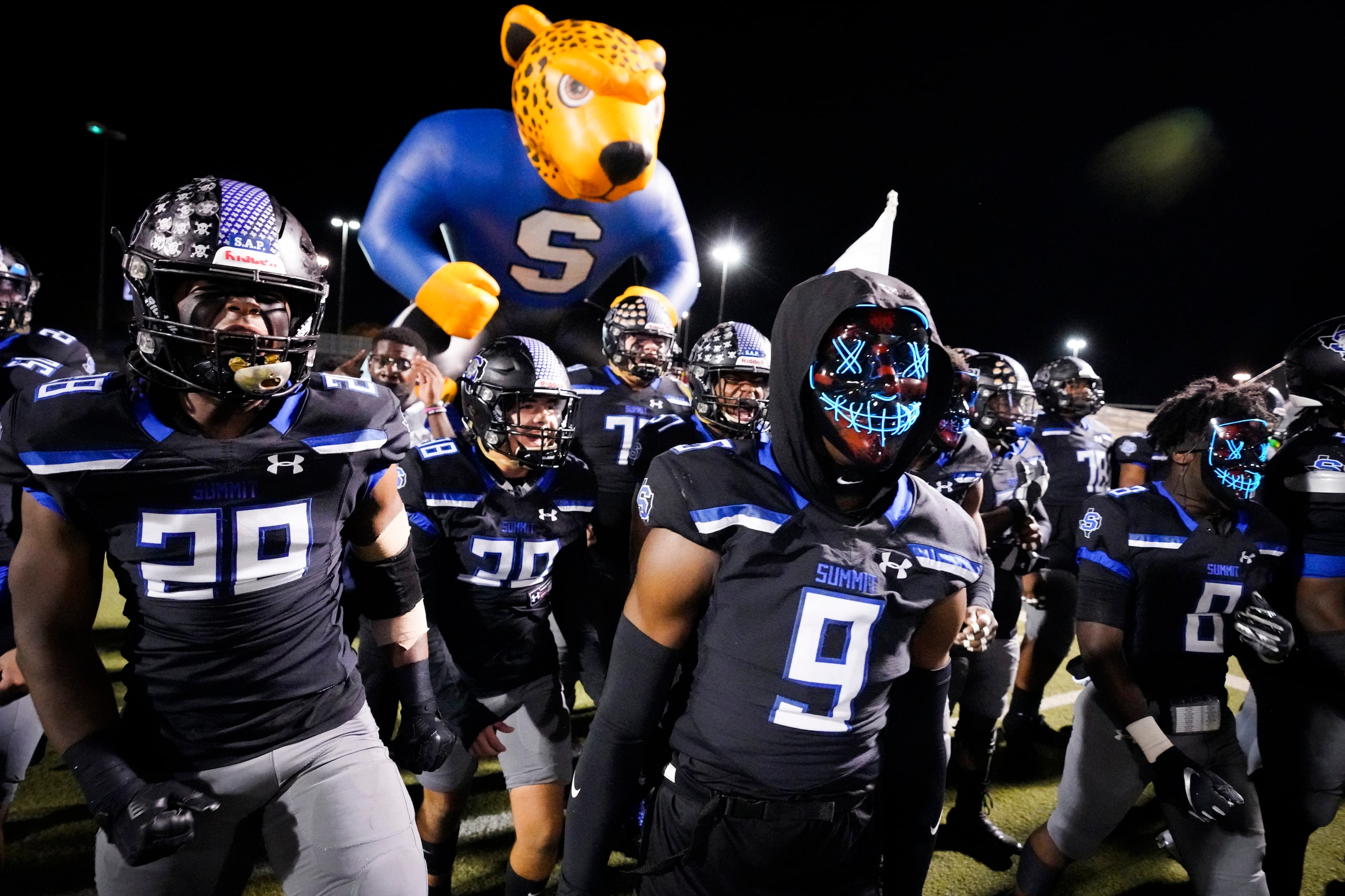 Mansfield Summit defensive back Tavare Smith Jr. (9) wheres a mask as he and linebacker...