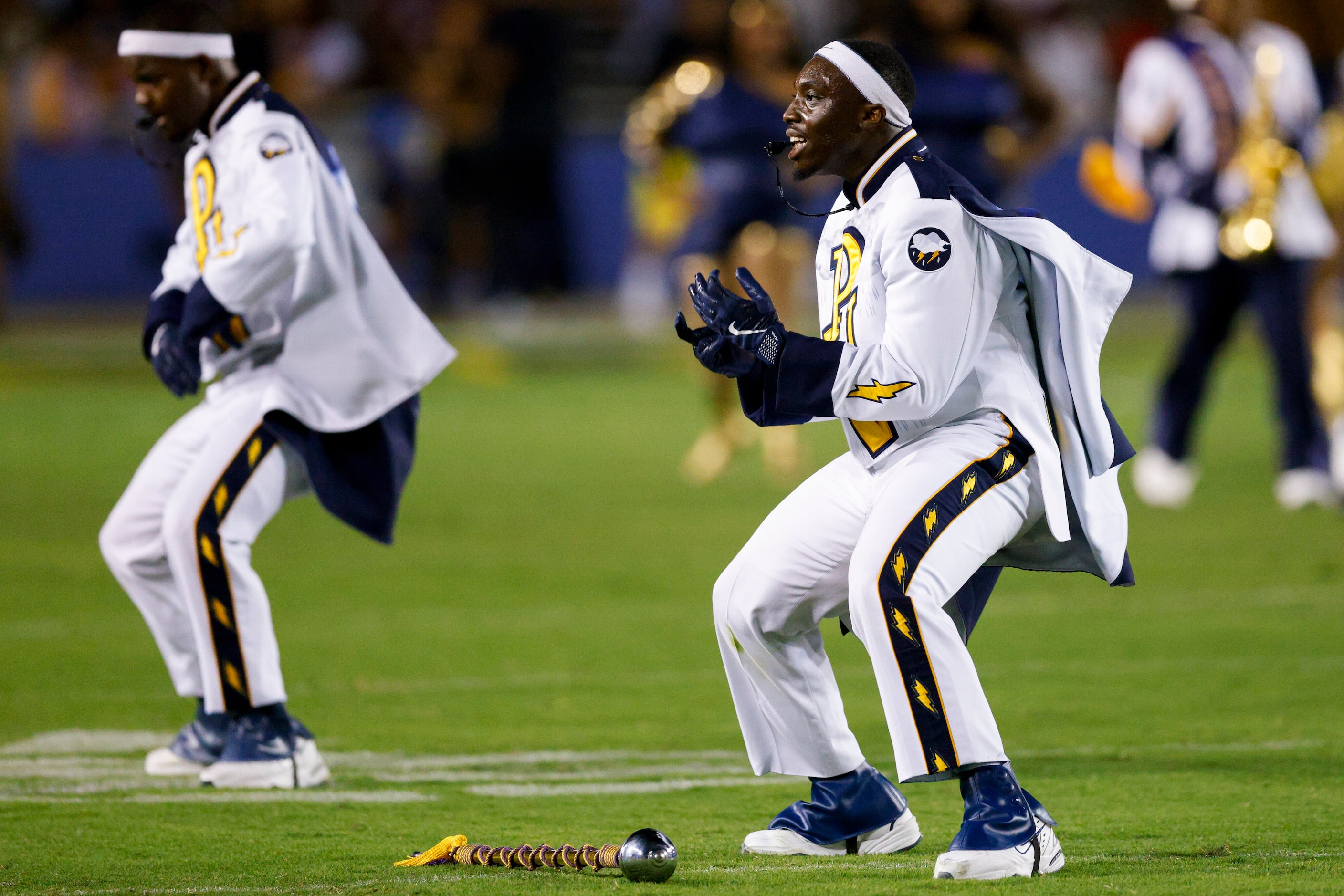 The Prairie View A&M marching band drum majors perform during halftime at the State Fair...