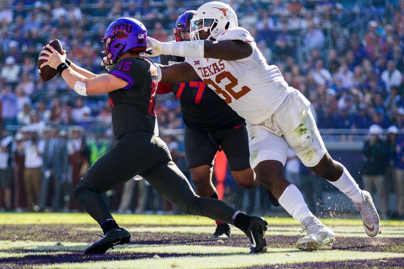 TCU Horned Frogs quarterback Max Duggan (15) avoids a safety attempt by Texas Longhorns...