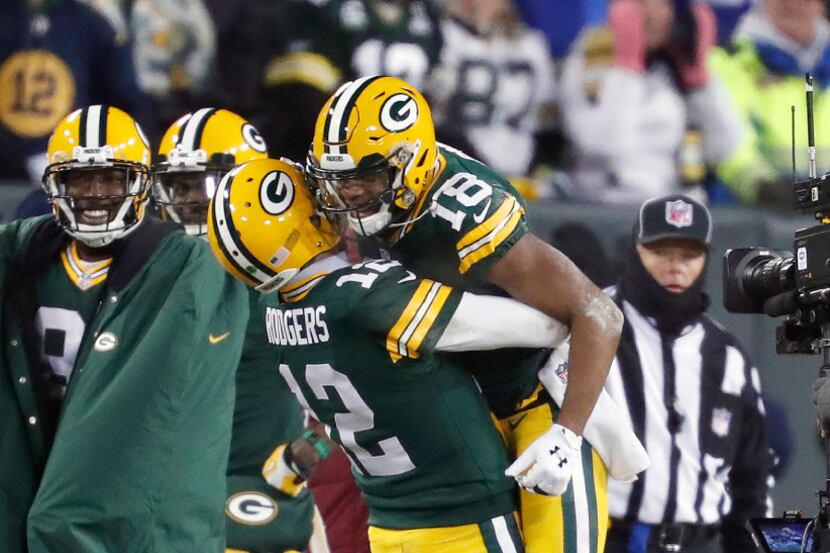 Green Bay Packers quarterback Aaron Rodgers (12) celebrates with wide receiver Randall Cobb...