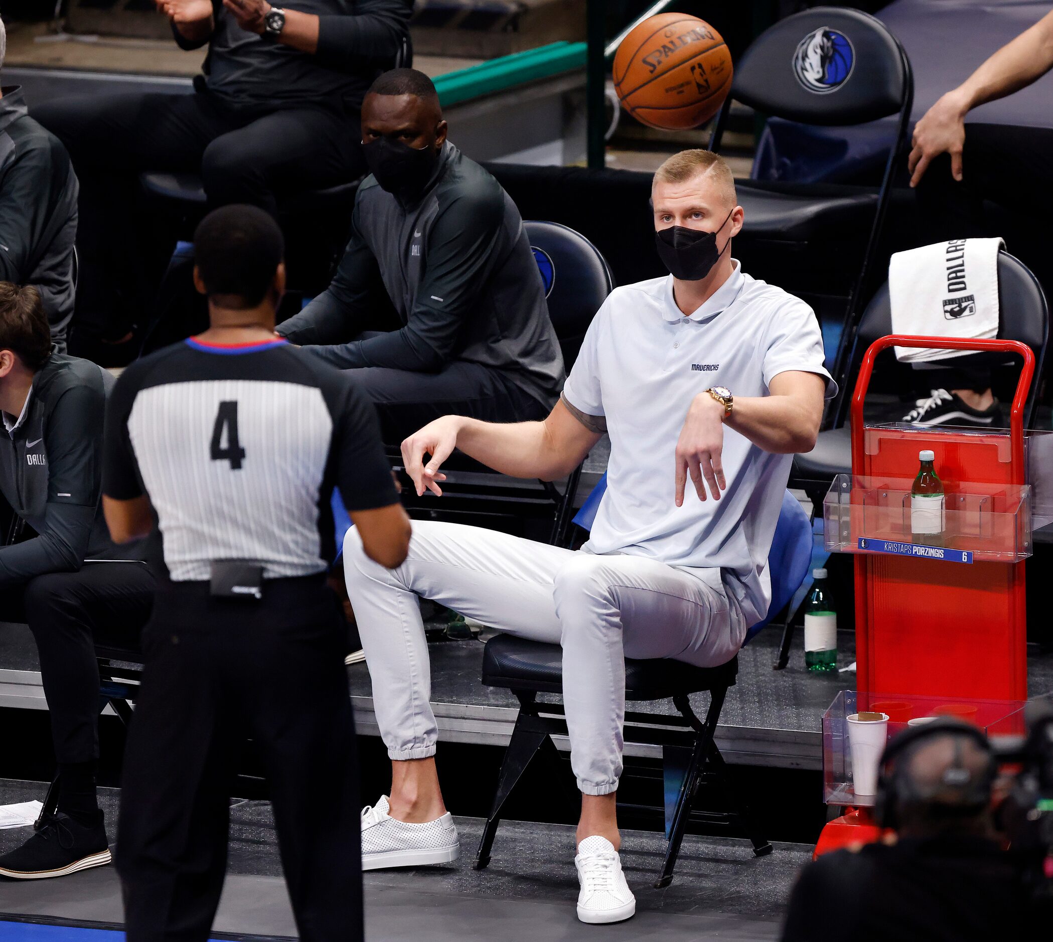 Dallas Mavericks injured center Kristaps Porzingis throws the ball back inbounds to the...