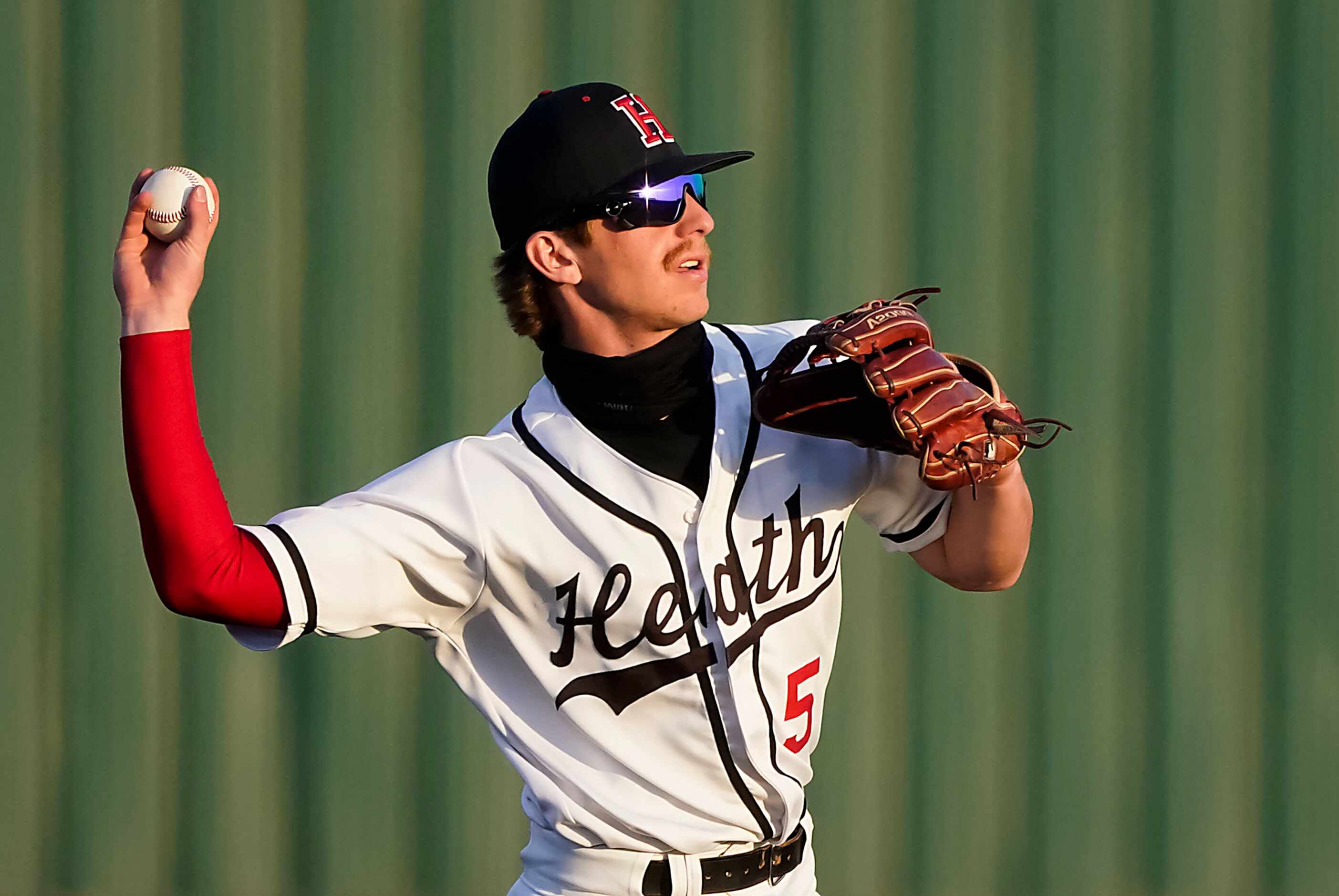 Rockwall-Heath shortstop Karson Krowka makes a throw to first during a district 10-6A high...