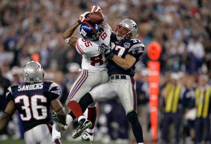 FILE - In this Feb. 3, 2008, file photo, New York Giants receiver David Tyree (85) catches a...