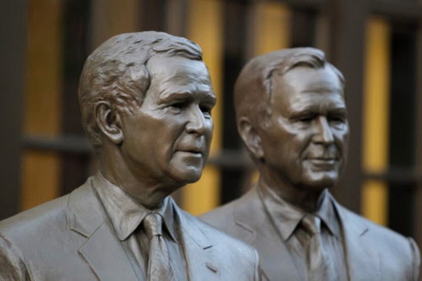 Two bronze statues of former U.S. Presidents George W. Bush and his father, George H.W....